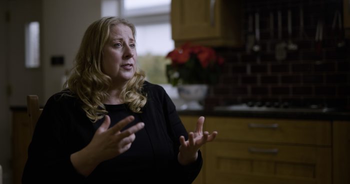 Lady looks past camera performing her own voice