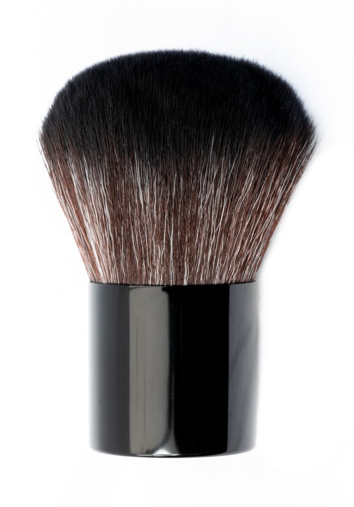 Detailed studio shot of a soft-bristled kabuki brush with black handle on clean white background.